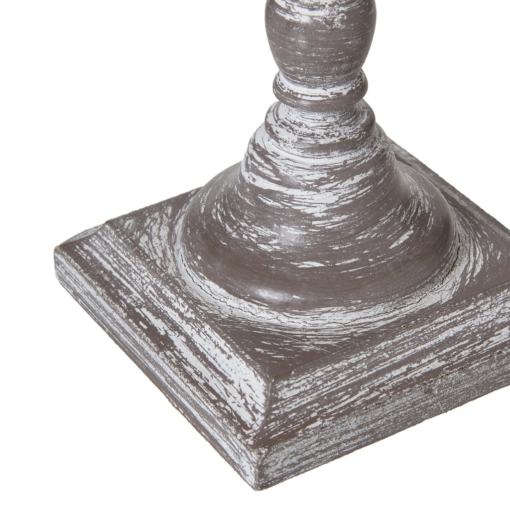 Decorative table lamp base with a square base and cylindrical top on a white background