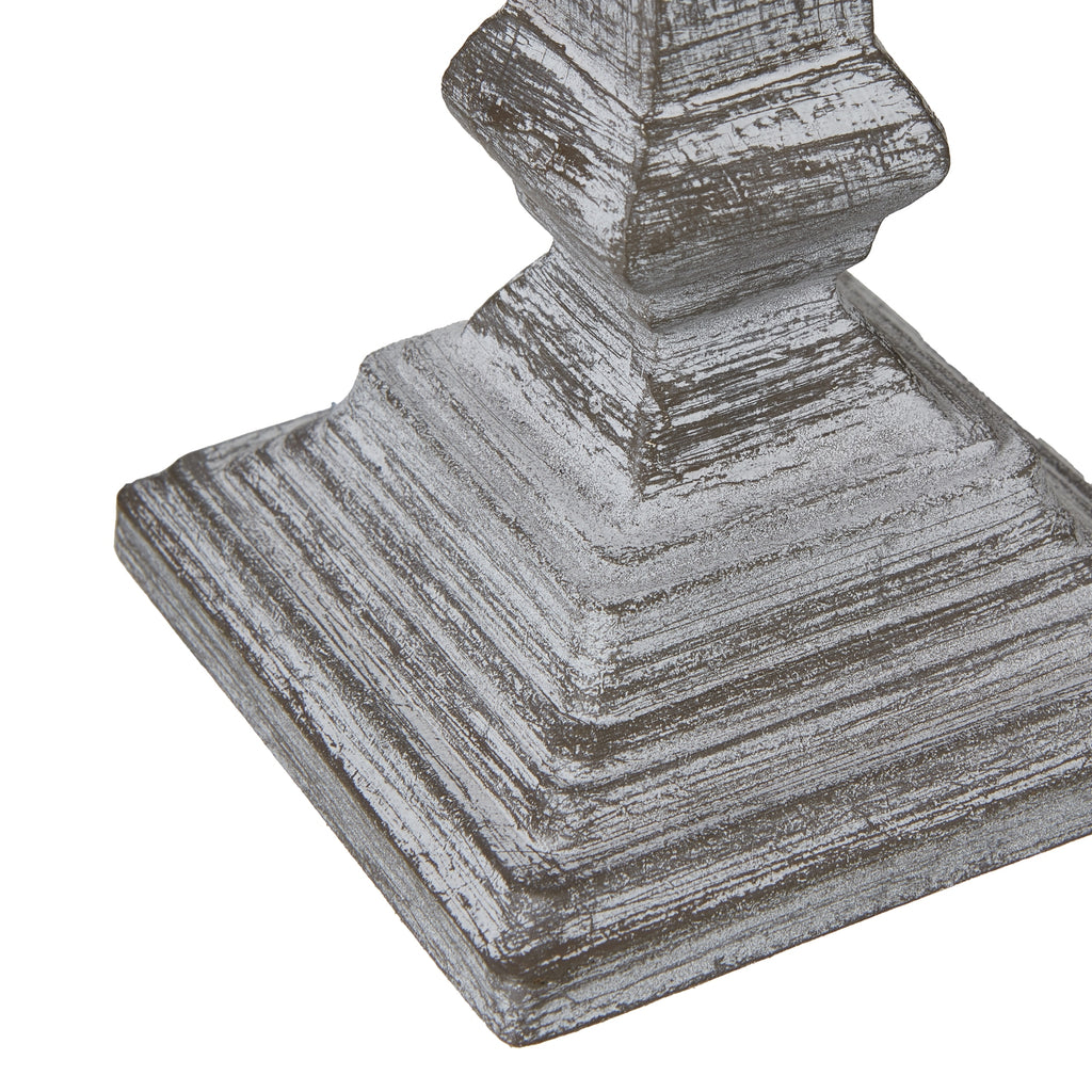 Decorative table lamp base with a textured surface on a white background