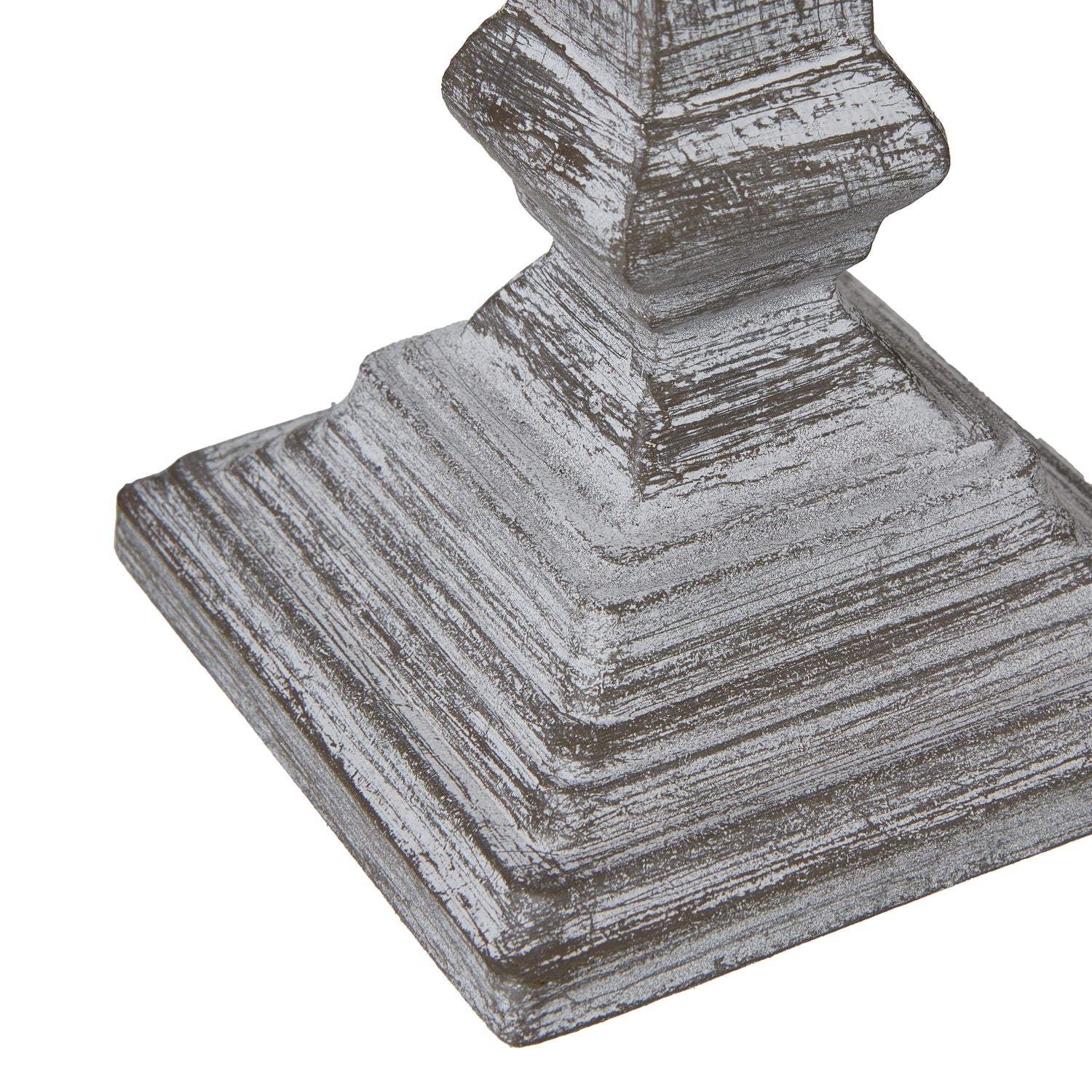 Decorative table lamp base with a textured surface on a white background