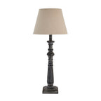 Table lamp with a beige shade and wooden base on a white background