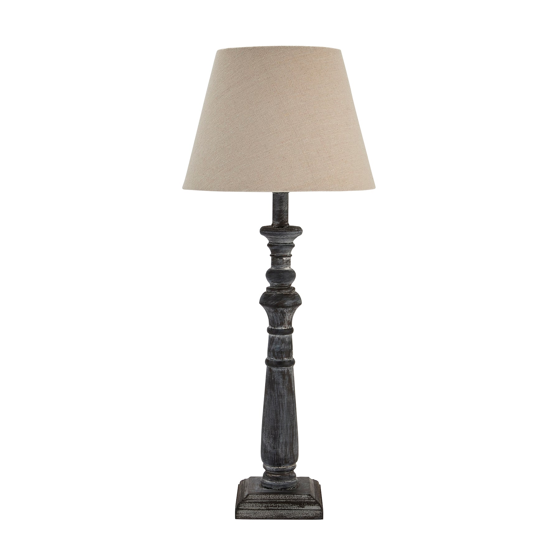 Table lamp with a beige shade and wooden base on a white background