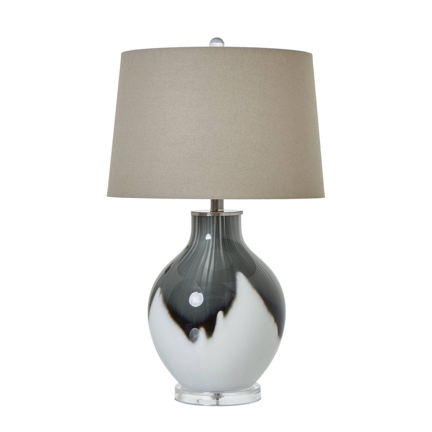 Table lamp with a grey and white glass base and beige lampshade on a white background
