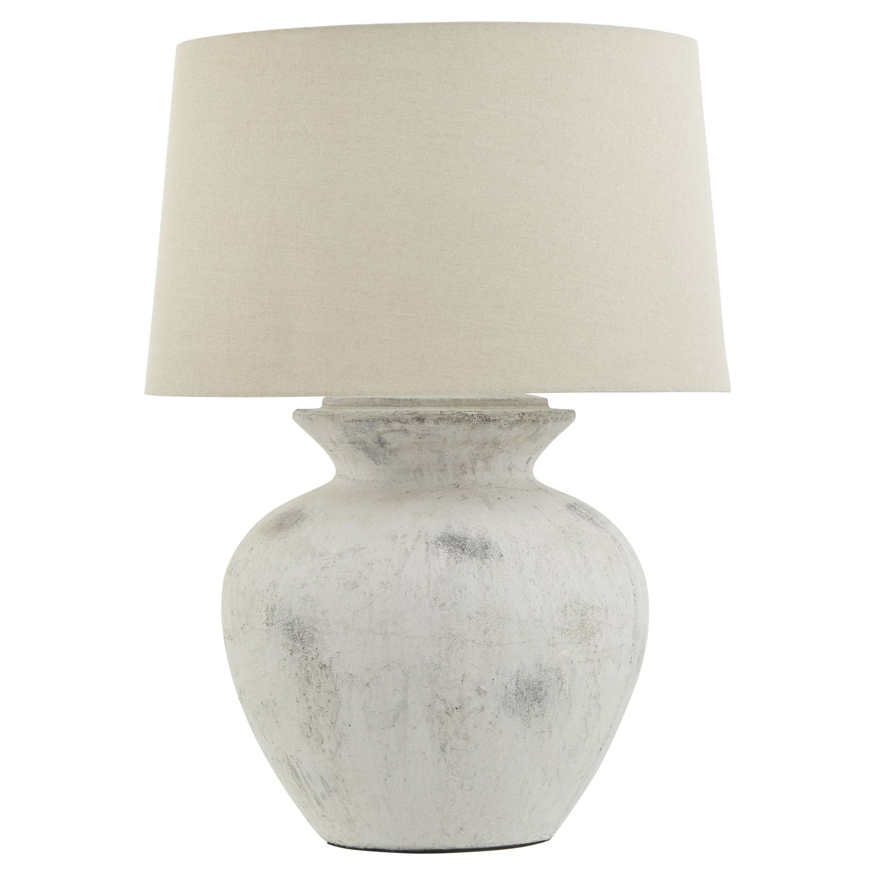 Table lamp with a textured white base and cream lampshade on a white background