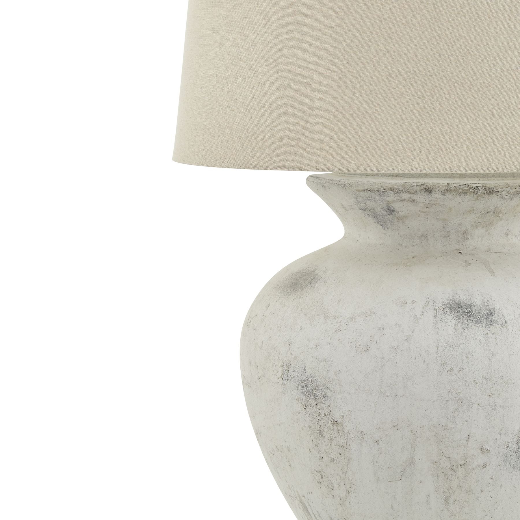 Table lamp with a textured white base and cream lampshade on a white background
