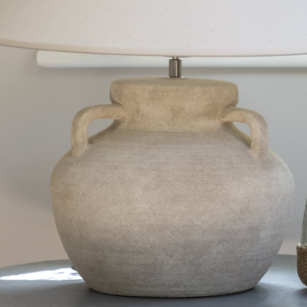 Beige textured lamp with two handles on a neutral background