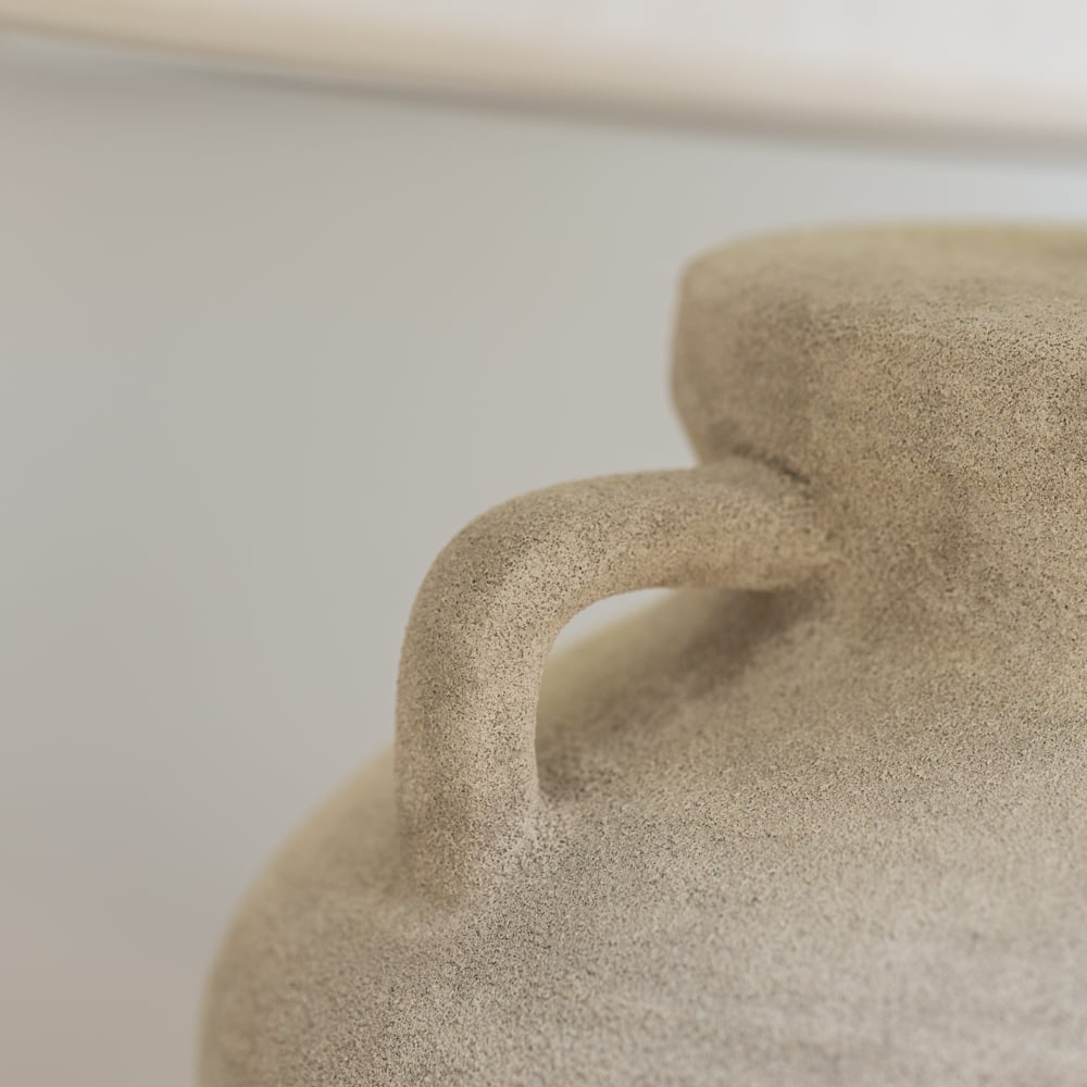 Close-up of a textured ceramic vase with a blurred background