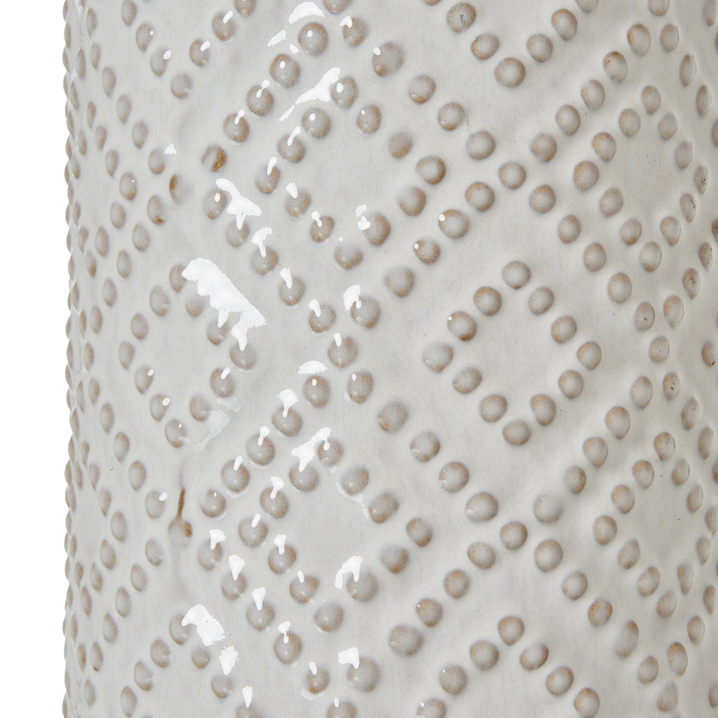 White ceramic table lamp with textured pattern on a white background