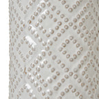 White ceramic table lamp with textured pattern on a white background