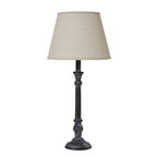 Table lamp with a cream shade on a white background