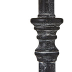 Close-up of dark wood table lamp stem with decorative top on a white background