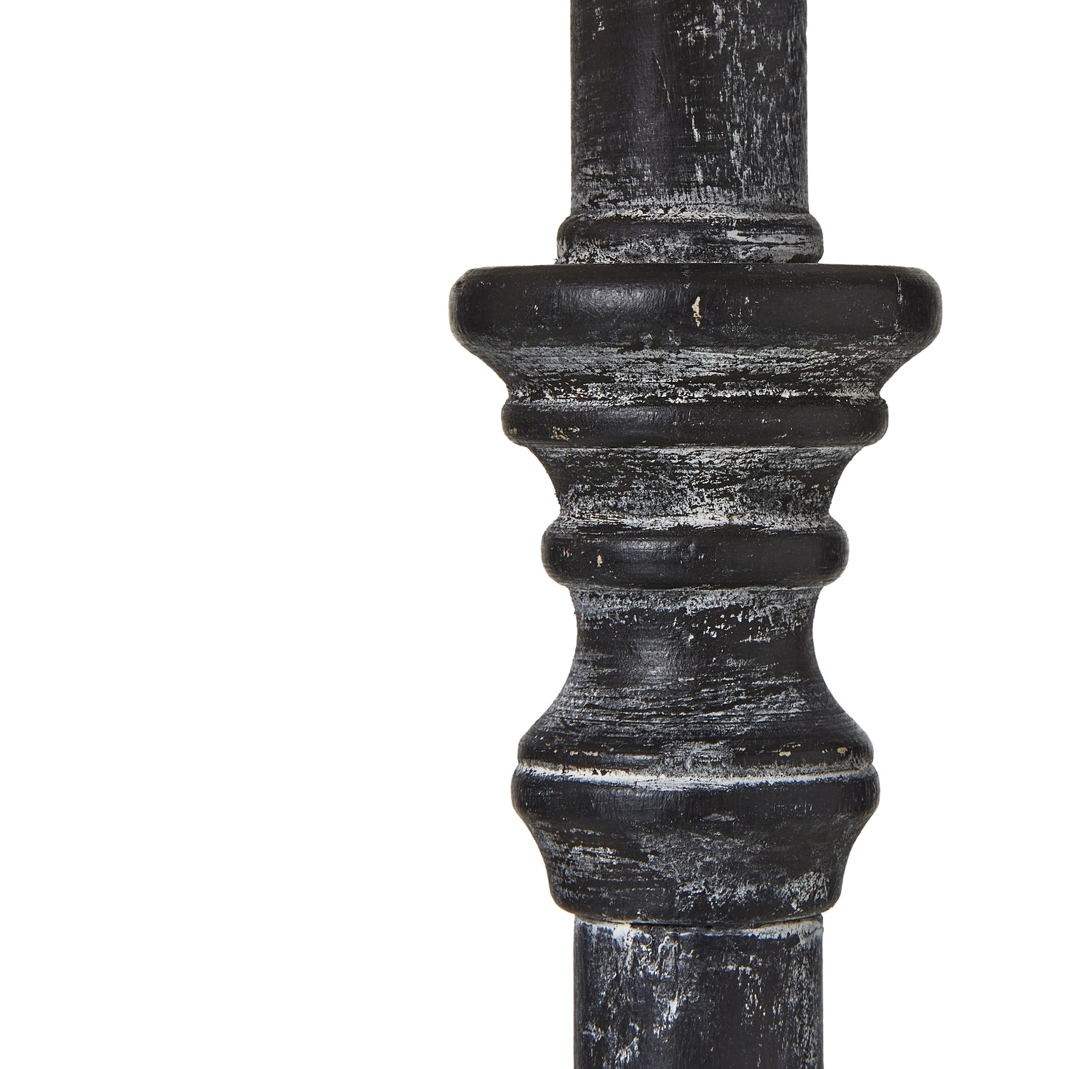 Close-up of dark wood table lamp stem with decorative top on a white background