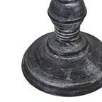 Close-up of a textured dark wood table lamp base on a white background