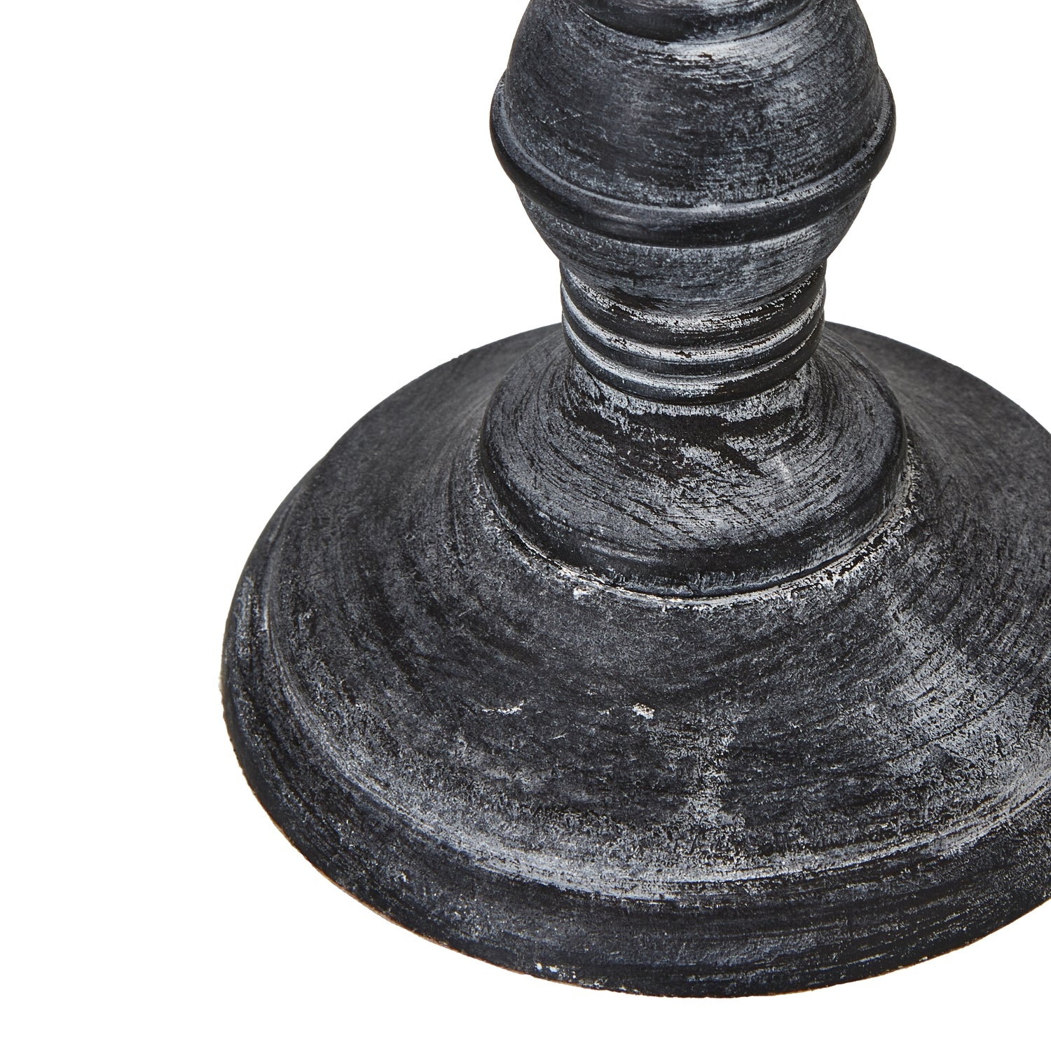 Close-up of a textured dark wood table lamp base on a white background