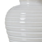 Close-up of a white ceramic ribbed vase on a white background