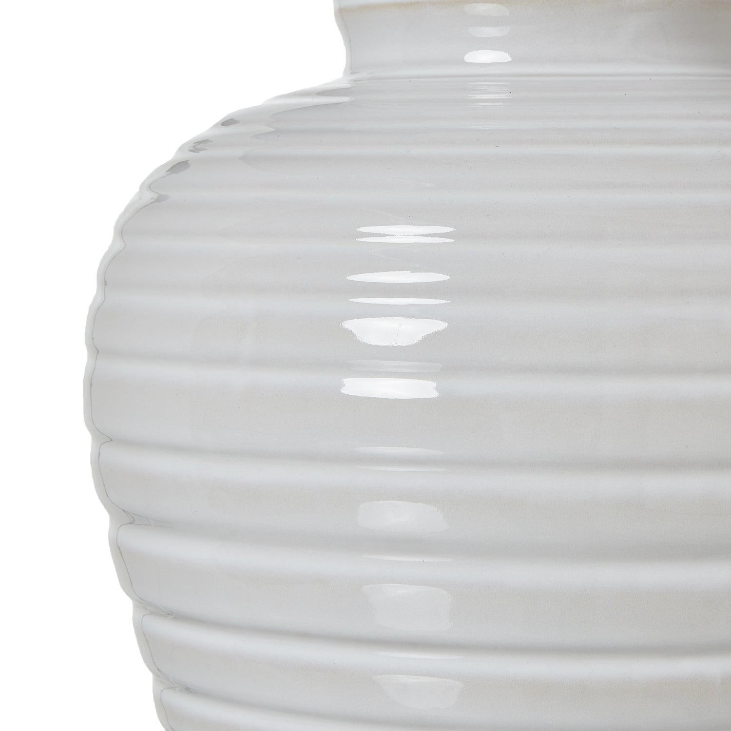 Close-up of a white ceramic ribbed vase on a white background