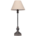 Table lamp with beige shade and metal base on a white background