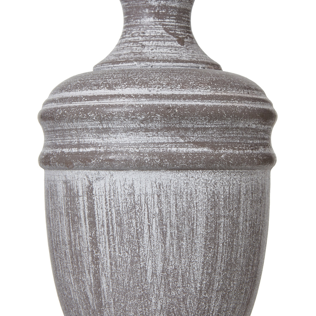 Decorative urn table lamp with a textured surface on a white background