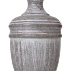 Decorative urn table lamp with a textured surface on a white background