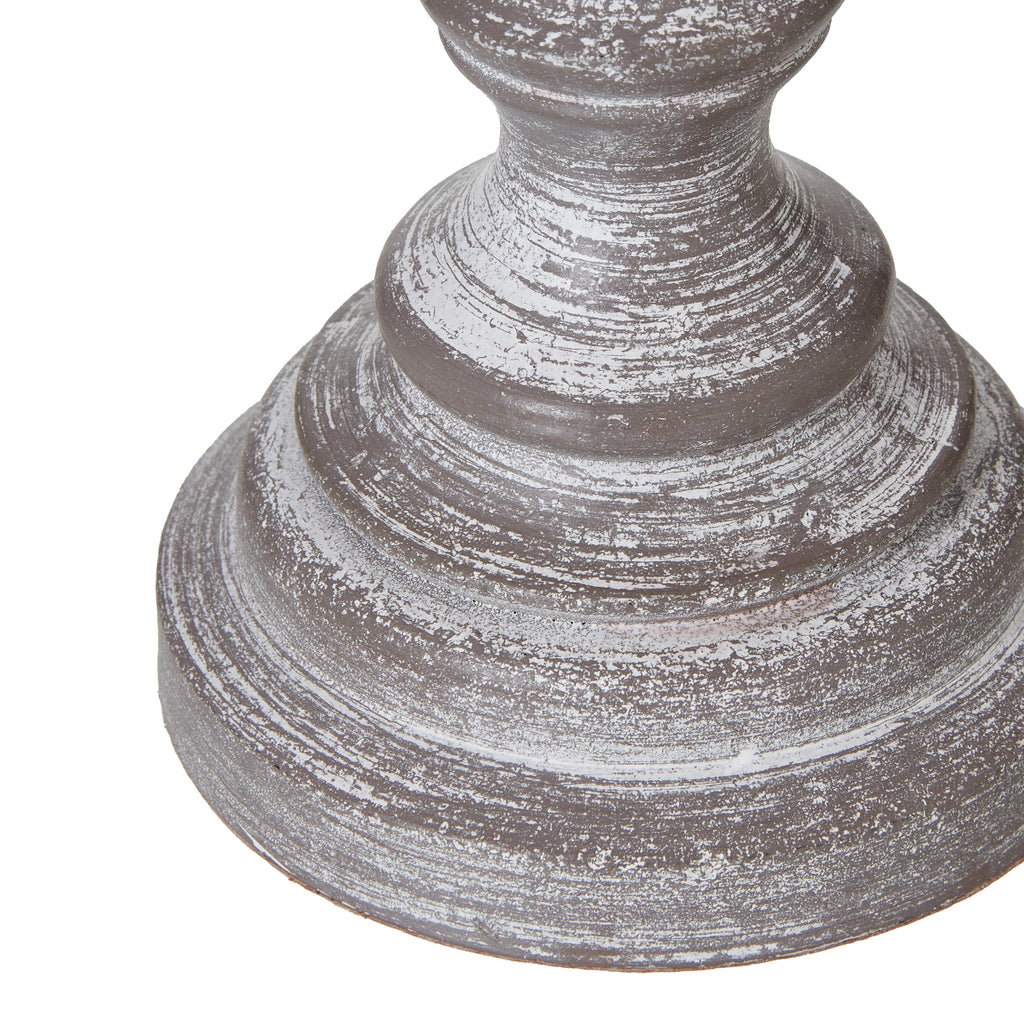 Decorative table lamp base with a textured surface on a white background