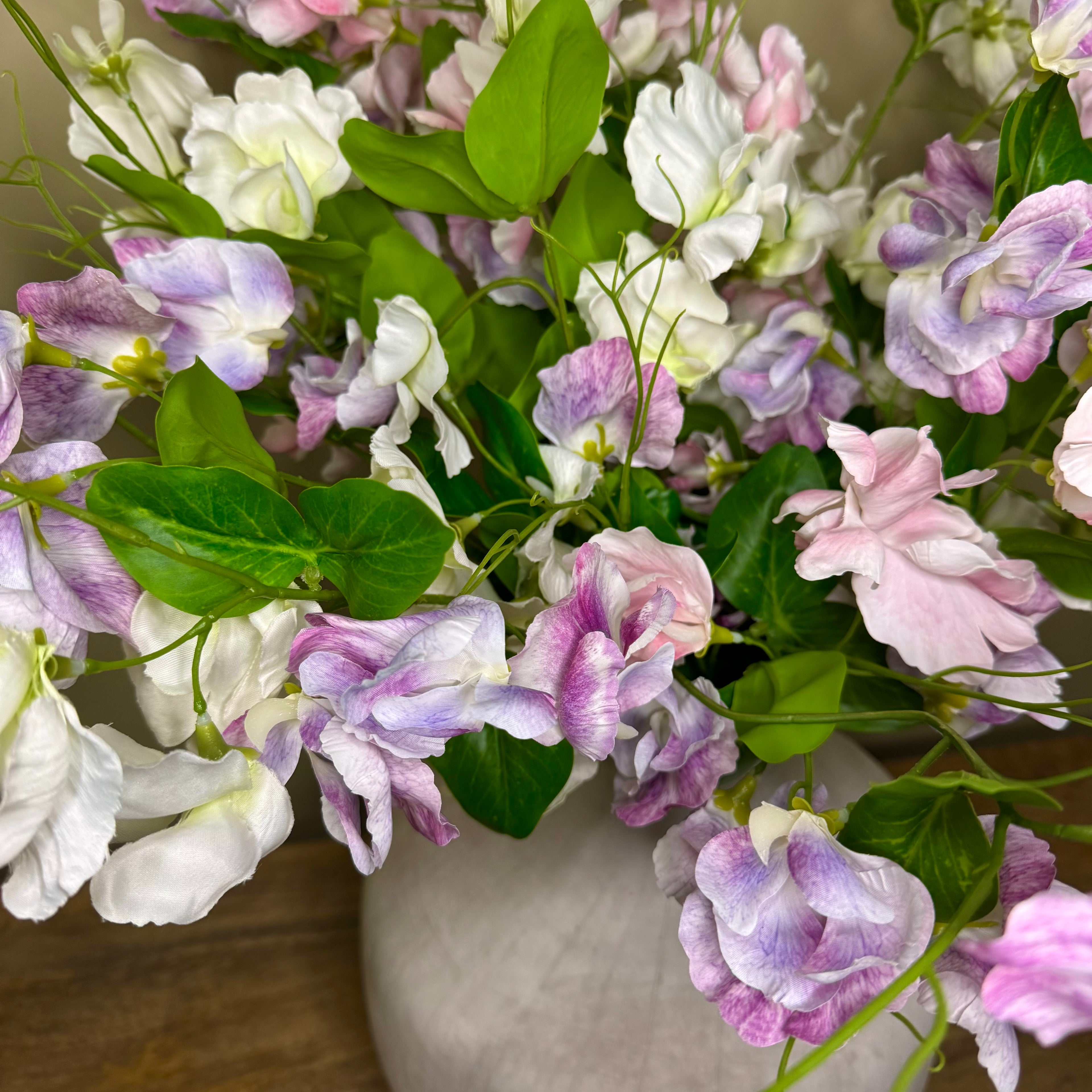Bouquet of pink, white, and purple flowers in a vase.