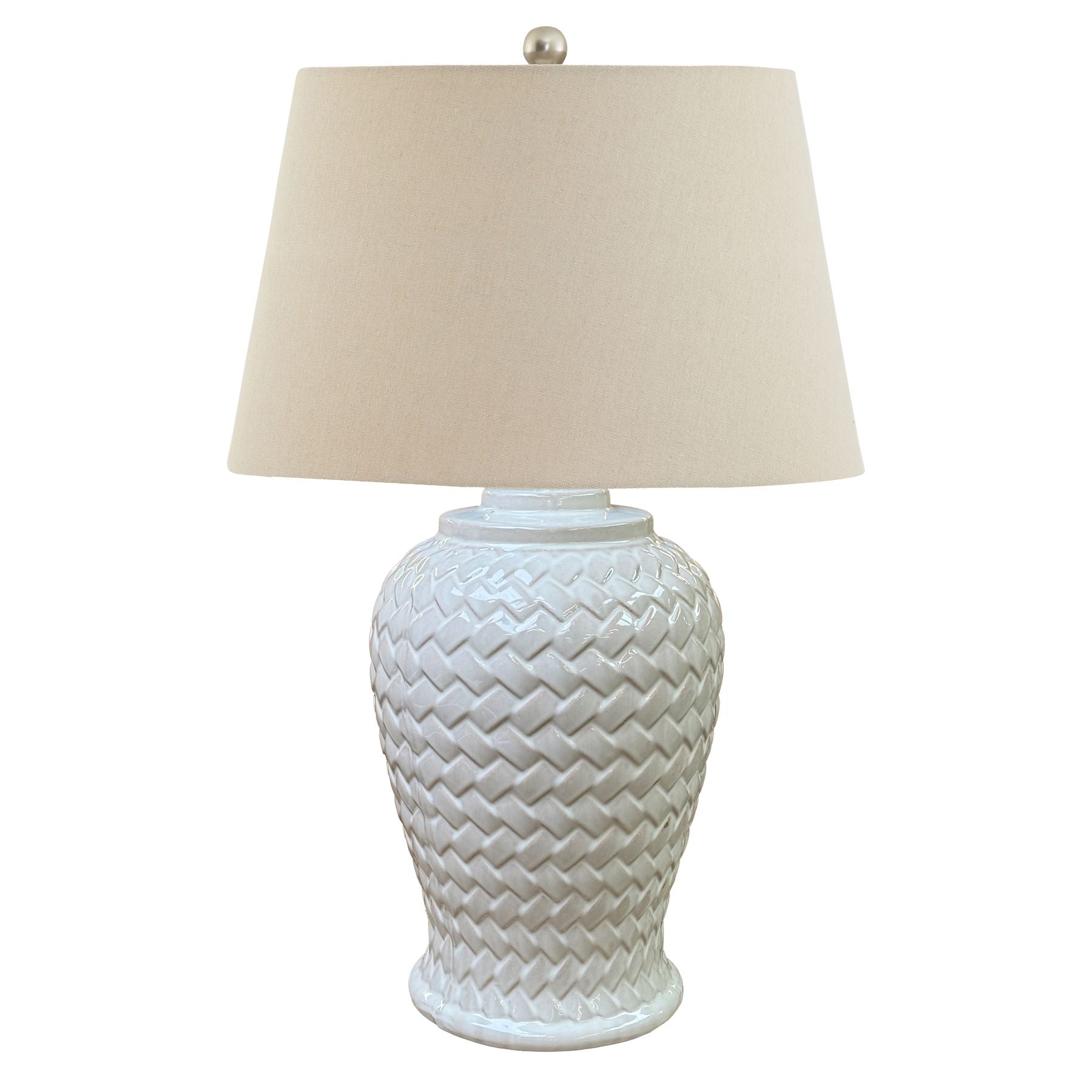 White chevron textured ceramic table lamp with a cream lampshade on a white background