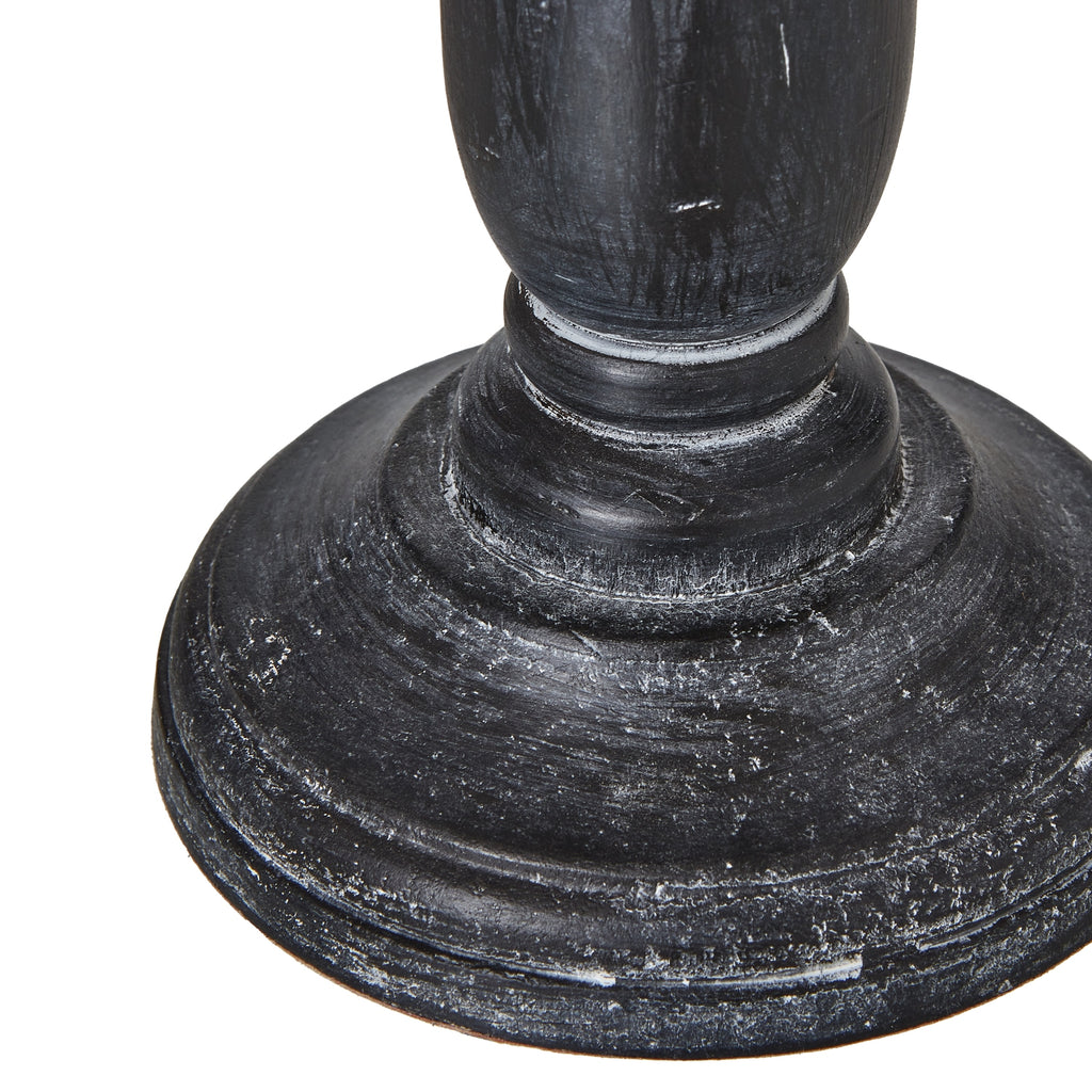 Close-up of dark wooden table lamp base on a white background