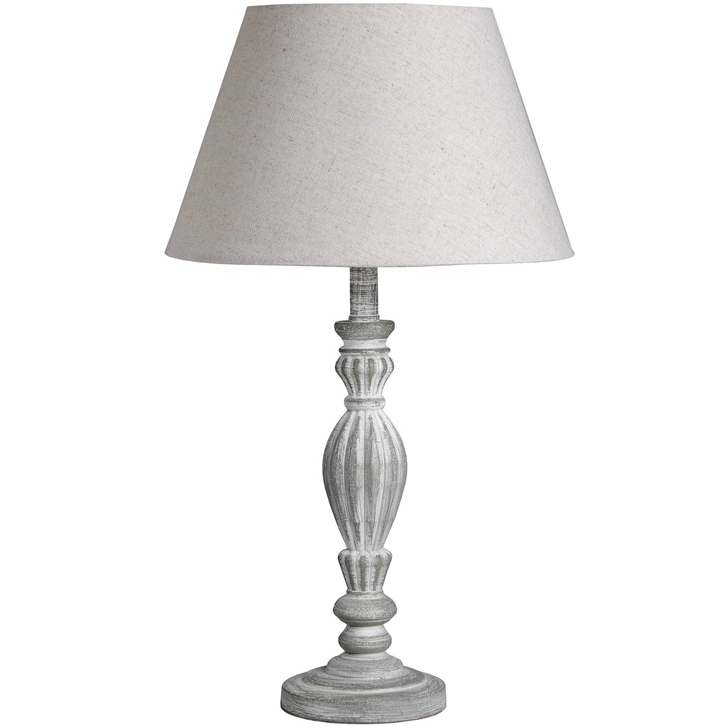 Table lamp with a grey base and cream lampshade on a white background