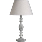 Table lamp with a grey base and cream lampshade on a white background