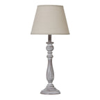 Table lamp with a cream shade and wooden base on a white background