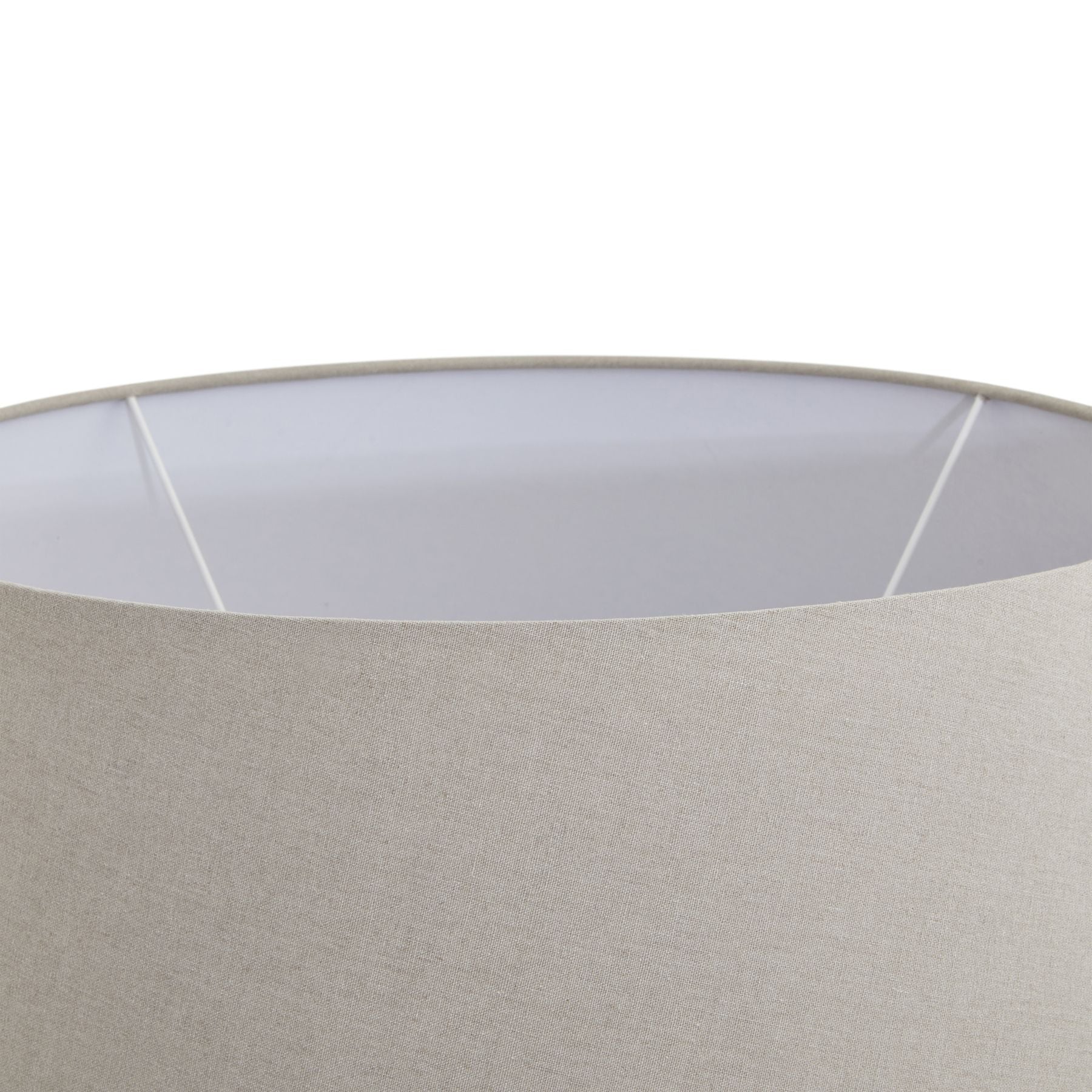 Close-up of a lampshade with a white inner rim and beige outer fabric.