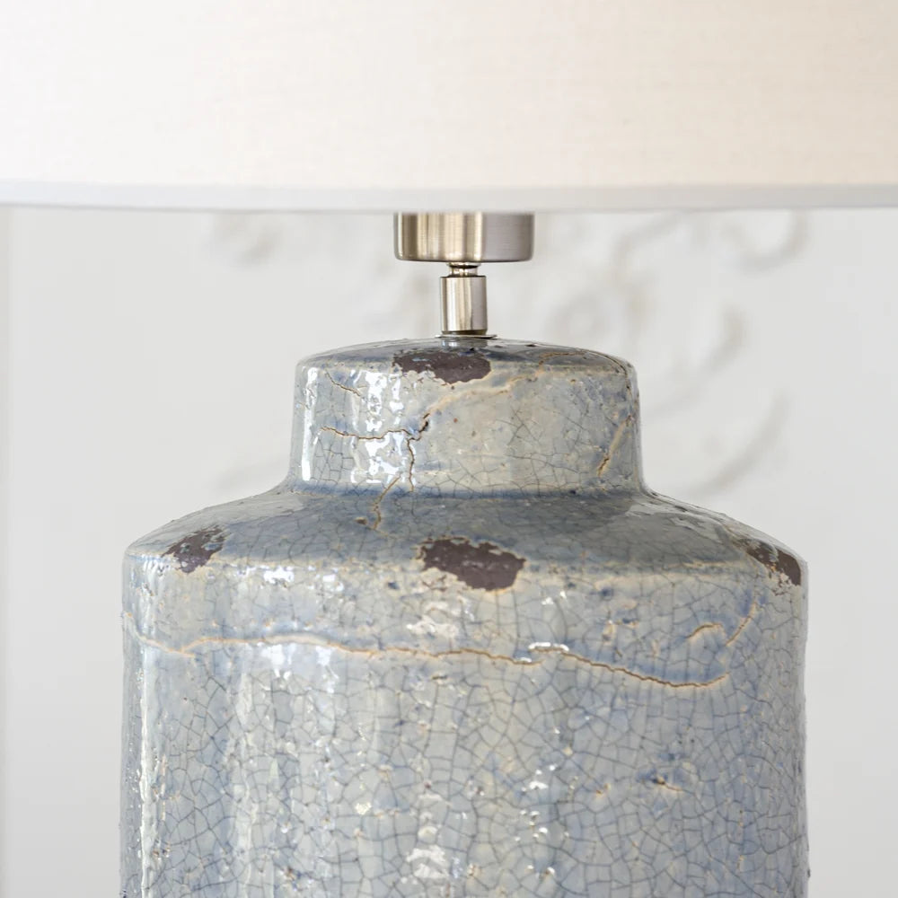 Decorative lamp with a cracked blue glaze finish on a white background